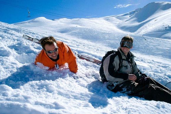 pair of men laughing in the snow