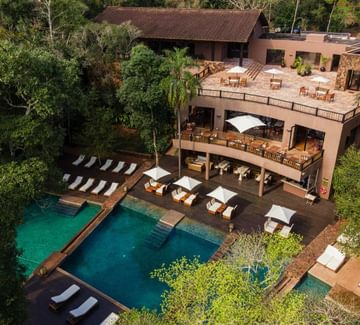 looking down on an inviting pool and a deck with lounging chairs near the iguazu falls