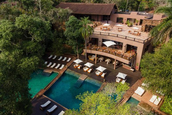 looking down on an inviting pool and a deck with lounging chairs near the iguazu falls
