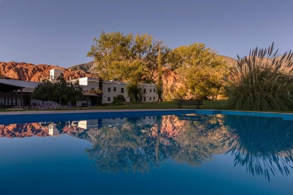 looking across the still swimming pool to a small hotel in purmamarca