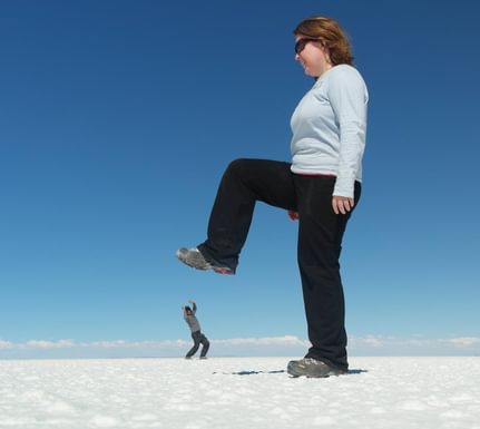 Bolivia uyuni salt flats optical illusion stamping on tiny man