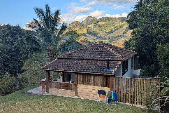 a cabin the rolling green hills of the serra do mar mountains