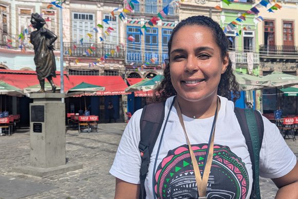 a friendly guide smiles in a colourful square in rio's historic centre