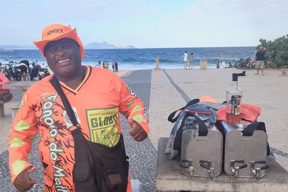 a smiling mate iced tea vendor on ipanema beach