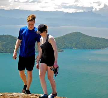 teenage siblings hiking above the sea in paraty bay