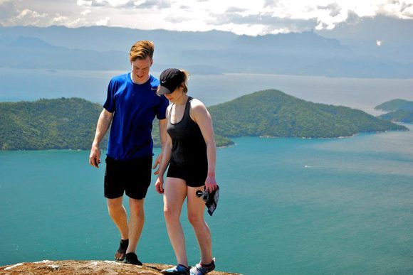 teenage siblings hiking above the sea in paraty bay