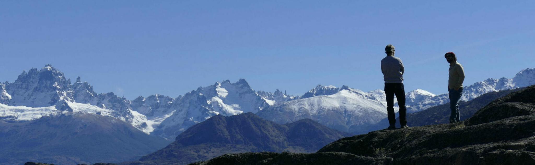 Chile patagonia aysen cerro castillo two people in silhouette with mountains behind
