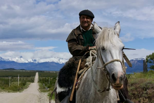 Chile patagonia carretera austral gaucho riding along road lago carrera