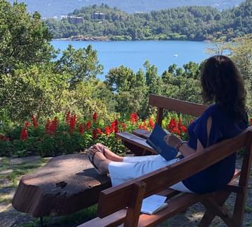 lady reading book at hotel by lake villarica