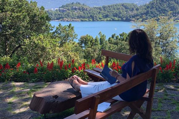 lady reading book at hotel by lake villarica