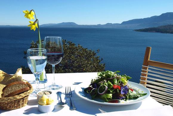 table with salad and wine above lago villarica