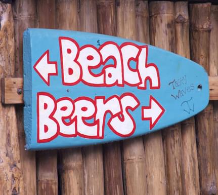 Costa rica caribbean beach beers signpost