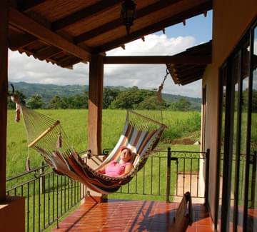 smiling lady in a hammock on a hotel terrace