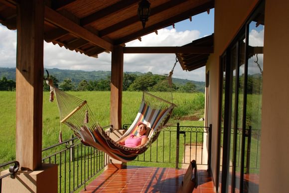 smiling lady in a hammock on a hotel terrace