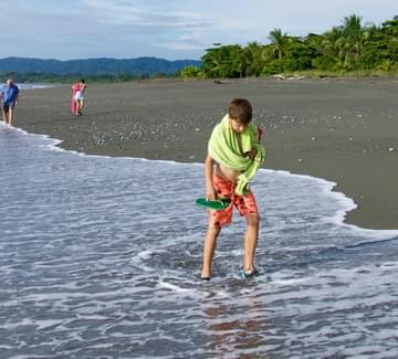 boy strolling on beach on osa peninsula