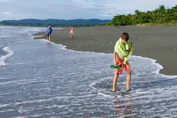 boy strolling on beach on osa peninsula