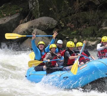group of smiling people rafting on the pacuare river