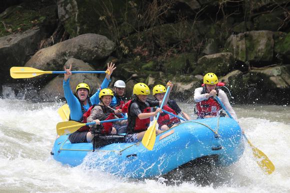group of smiling people rafting on the pacuare river