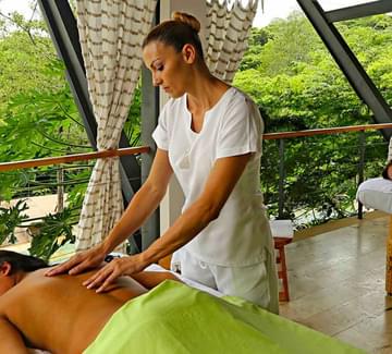 two ladies receiving spa massage on a deck in rio perdido