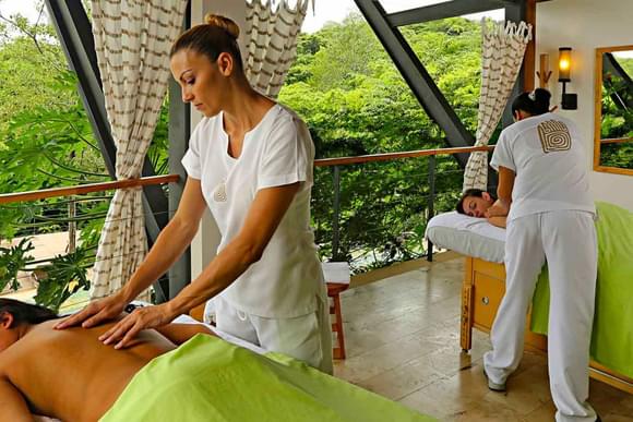 two ladies receiving spa massage on a deck in rio perdido