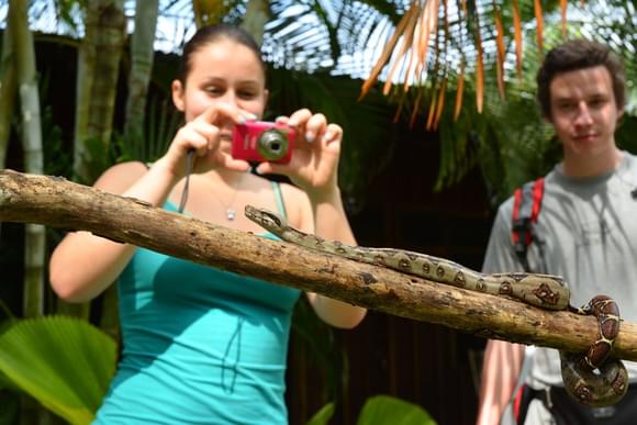teenagers taking photo of snake tortuguero