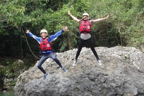 family rafting the pacuare river with enthusastic guide posing for the camera