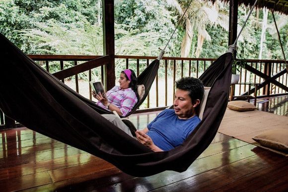 swinging in hammock at amazon lodge in peru