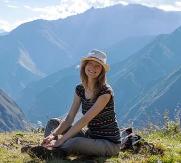 smiling girl posing in front of mountains in peru