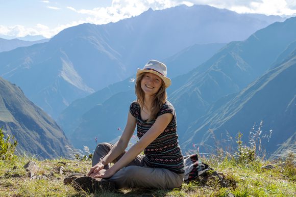 smiling girl posing in front of mountains in peru