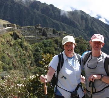 smiling couple walking inca trail