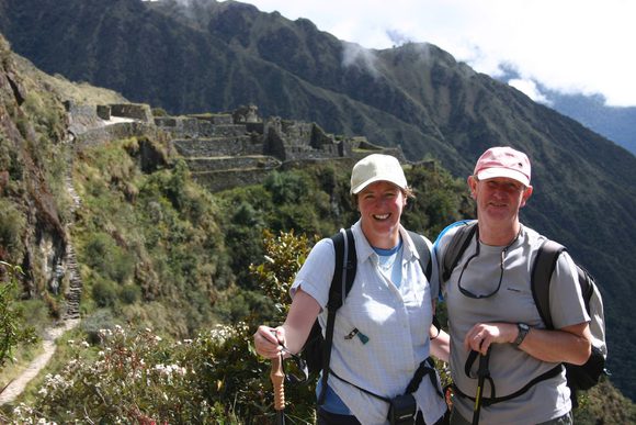 smiling couple walking inca trail