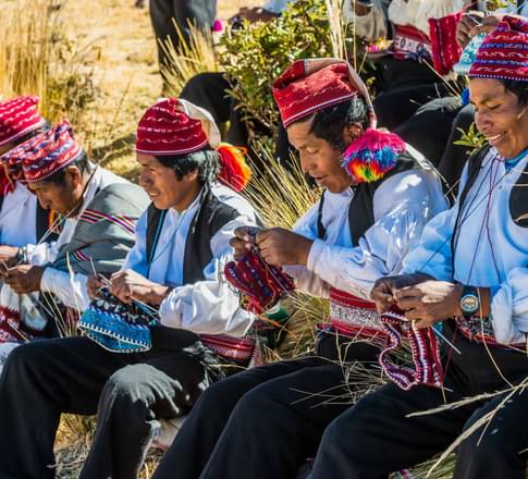Peru lake titicaca men weaving in the peruvian andes at taquile island