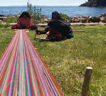 andean lady on island in lake titicaca