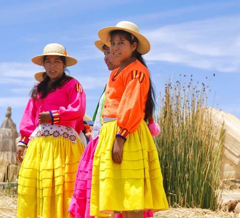 Peru lake titicaca unidentified women in traditional dresses welcome tourists in uros island