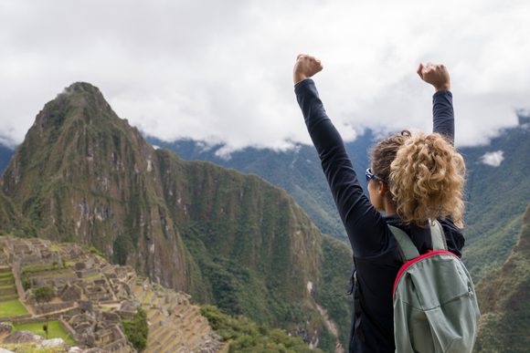 girl arriving at machu picchu