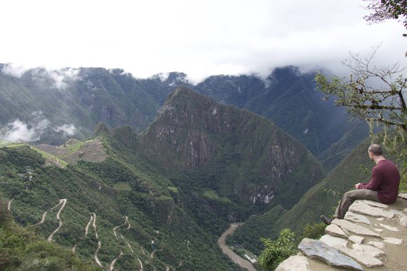 man sitting at machu picchu sun gate