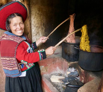 Peru sacred valley chinchero weaver dying wool over stove