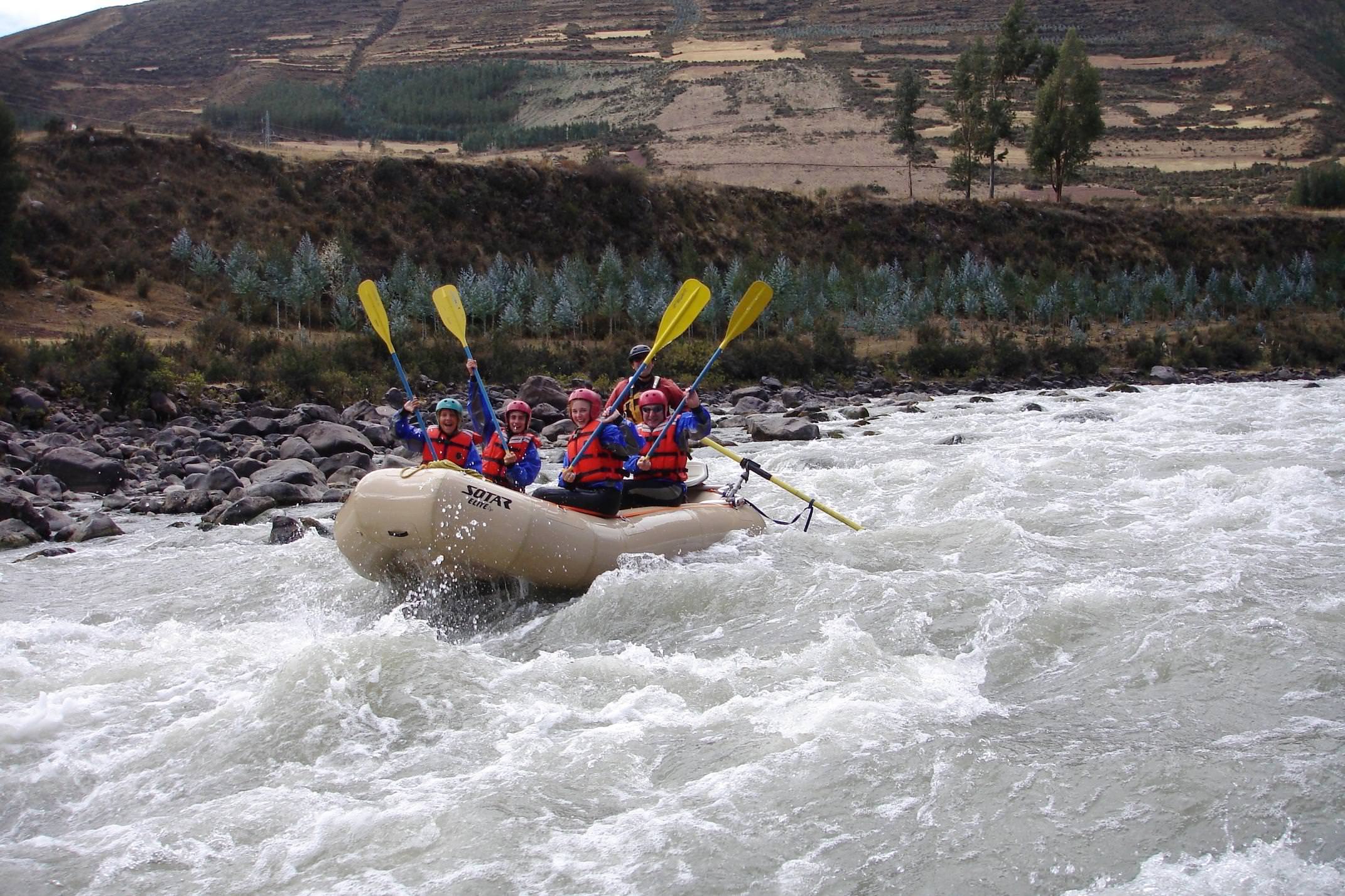 Peru sacred valley group rafting oars aloft