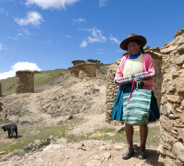 a traditinally dressed andean woman walking in the sacred valley