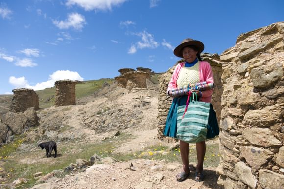 a traditinally dressed andean woman walking in the sacred valley