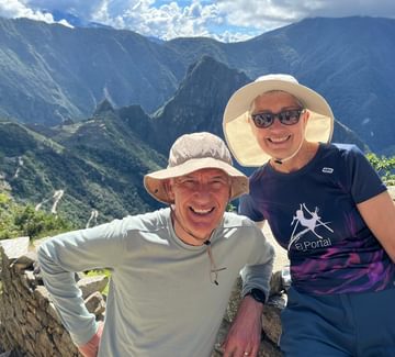 couple posing for a photo on the inca trail above machu picchu