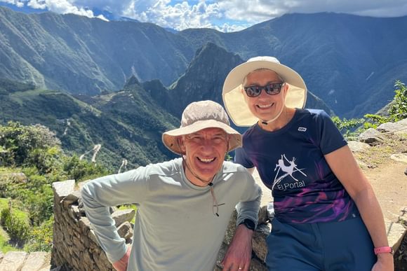 couple posing for a photo on the inca trail above machu picchu