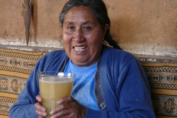 peru andes lady with chicha smiling