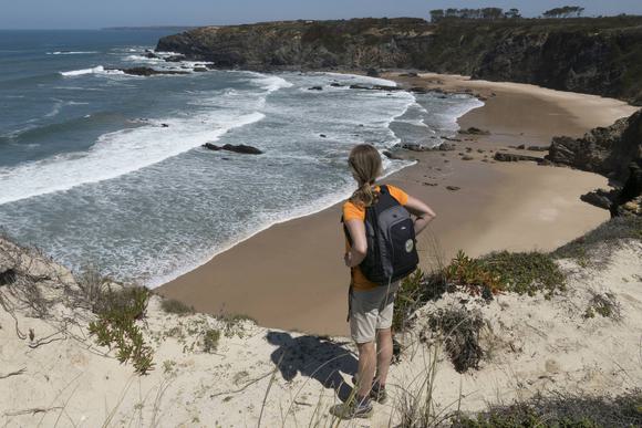 hiker looking over beach on costa vicentina