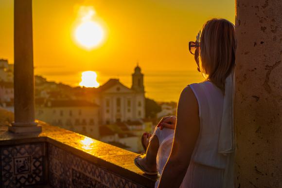 lady watching sunset in lisbon