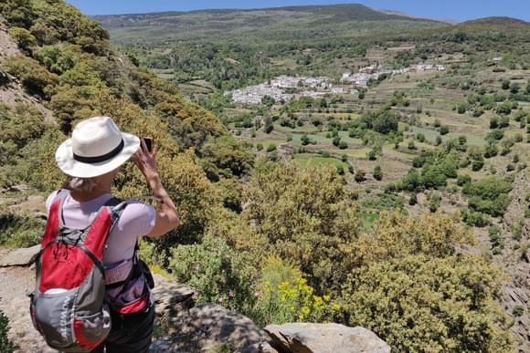 woman taking photo of village in the alpujarra