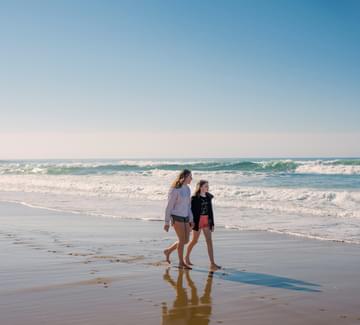 girls walking on beach in basque country