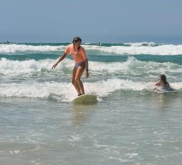 girls surfing off beach in northern spain