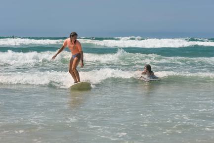 girls surfing off beach in northern spain
