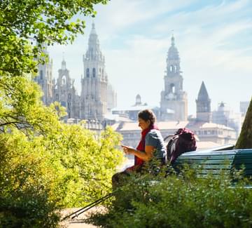 pilgrim sitting in front of santiago cathedral